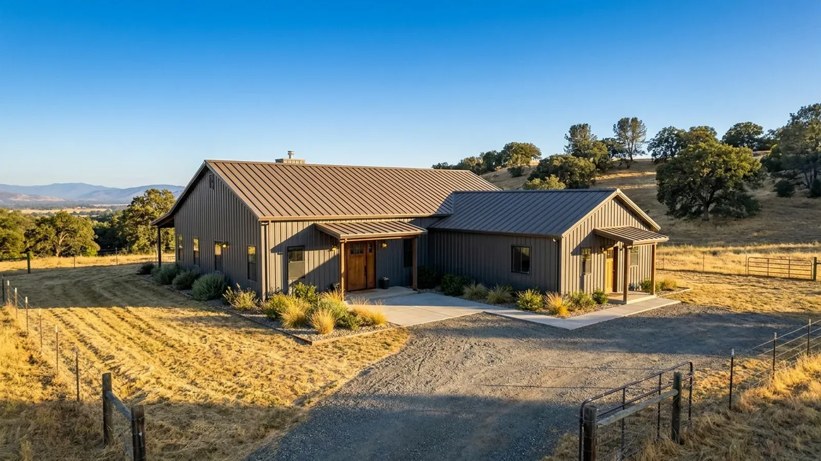 A barndominium with a smaller attached in-law suite wing that has its own separate covered entry, distinct from the main entry.